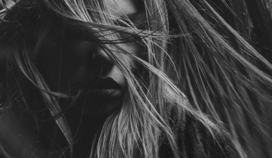 Artistic black and white portrait photography emphasizing mood and expression.