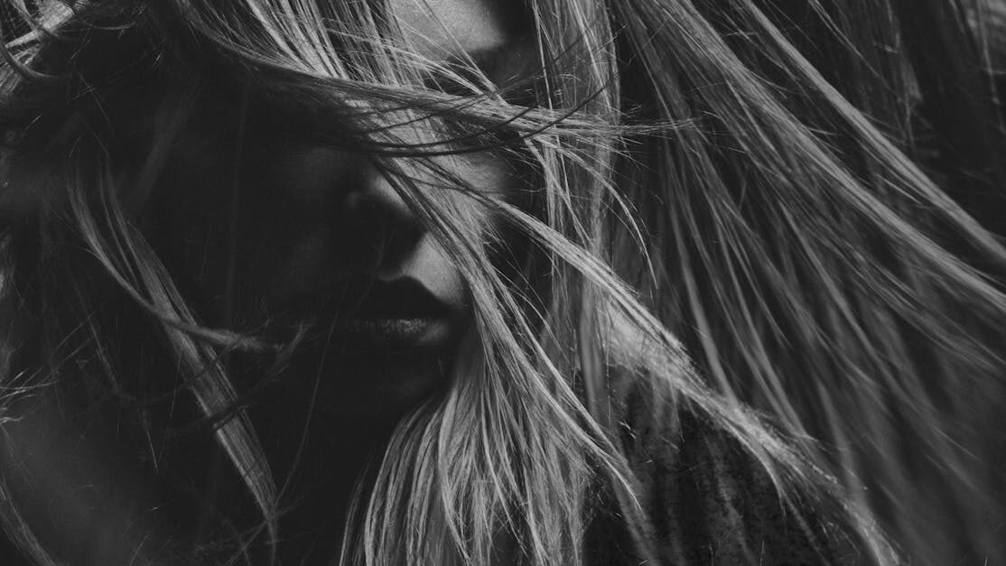 Artistic black and white portrait photography emphasizing mood and expression.